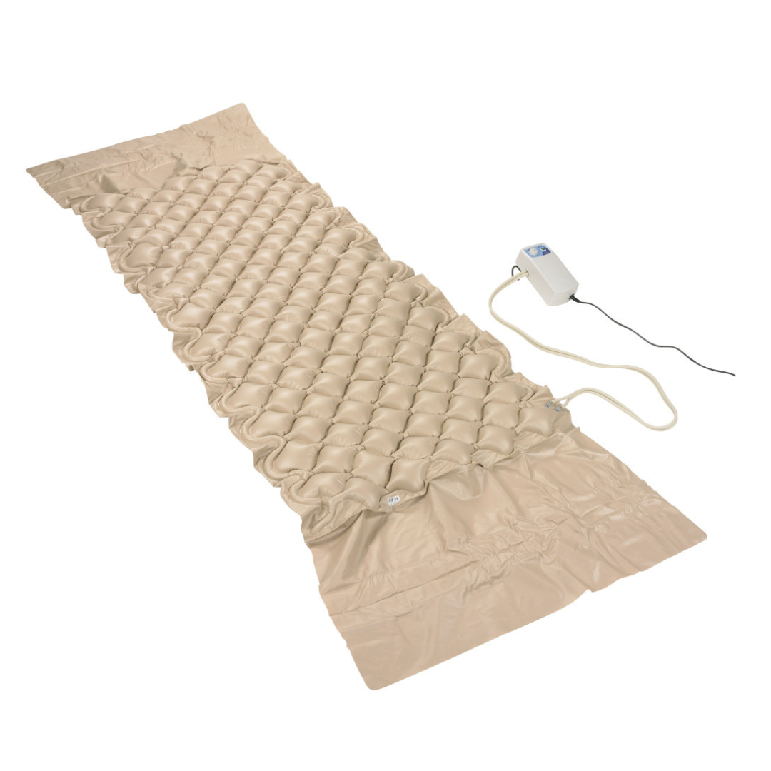 The Drive Med-Aire Alternating Pressure Pump and Pad System features a beige inflatable mattress with a textured, bubble-like surface and an attached pump connected by a cord, displayed on a white background.